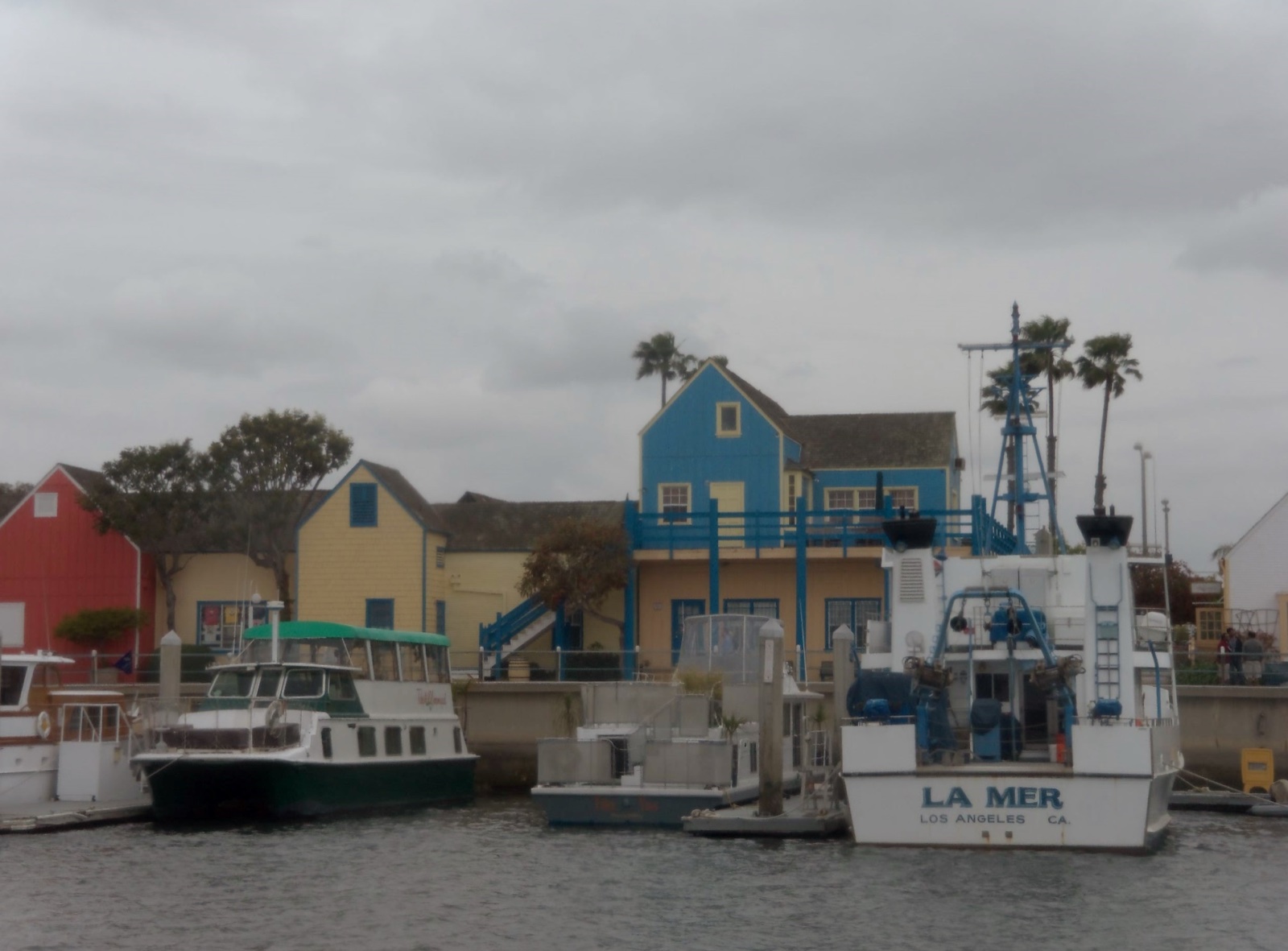 Fisherman's Village on the Marina del Rey waterfront — shingled New England-style storefronts and the lighthouse tower along the promenade